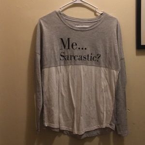 Gray long sleeve shirt: ”me...sarcastic? never.”